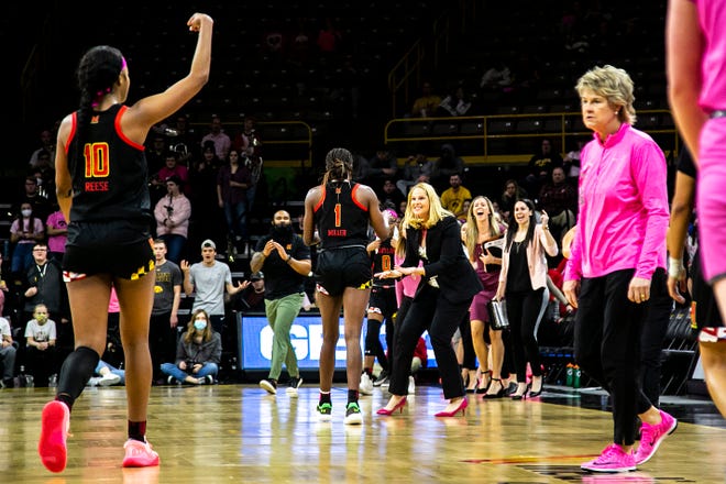 Maryland head coach Brenda Frese high-fives Maryland guard Diamond Miller (1) heading into a timeout as Iowa head coach Lisa Bluder, right, looks on during a NCAA Big Ten Conference women's basketball game, Monday, Feb. 14, 2022, at Carver-Hawkeye Arena in Iowa City, Iowa.
