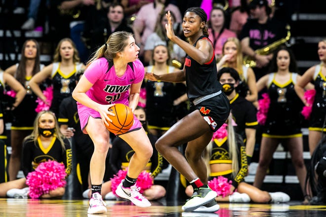 Iowa guard Kate Martin (20) drives to the basket as Maryland guard Diamond Miller, right, defends during a NCAA Big Ten Conference women's basketball game, Monday, Feb. 14, 2022, at Carver-Hawkeye Arena in Iowa City, Iowa.
