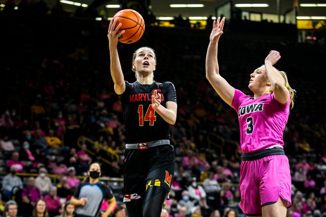 Maryland guard Taisiya Kozlova (14) shoots a basket as Iowa guard Sydney Affolter (3) defends during a NCAA Big Ten Conference women's basketball game, Monday, Feb. 14, 2022, at Carver-Hawkeye Arena in Iowa City, Iowa.