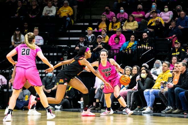 Maryland's Angel Reese (10) forces a turnover against Iowa guard Caitlin Clark (22) during a NCAA Big Ten Conference women's basketball game, Monday, Feb. 14, 2022, at Carver-Hawkeye Arena in Iowa City, Iowa.