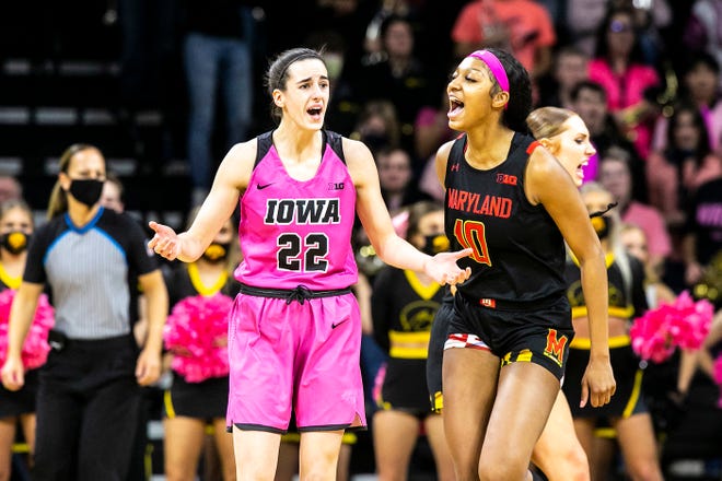 Iowa guard Caitlin Clark (22) and Maryland's Angel Reese, right, react to a call during a NCAA Big Ten Conference women's basketball game, Monday, Feb. 14, 2022, at Carver-Hawkeye Arena in Iowa City, Iowa.