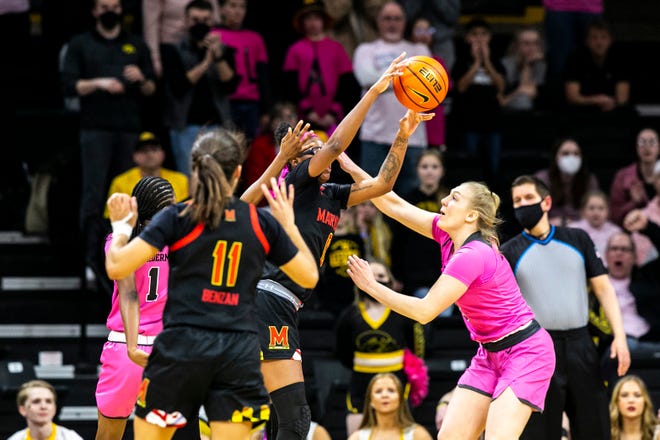 Maryland guard Shyanne Sellers (0) passes the ball as Iowa guards Tomi Taiwo, left, and Sydney Affolter defend during a NCAA Big Ten Conference women's basketball game, Monday, Feb. 14, 2022, at Carver-Hawkeye Arena in Iowa City, Iowa.