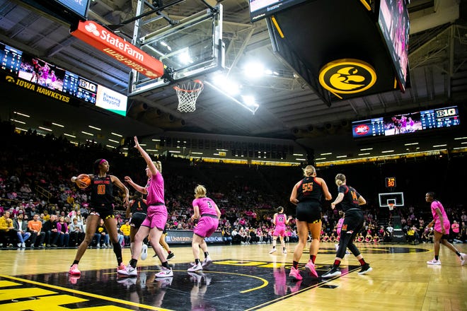 Maryland's Angel Reese (10) pulls down a rebound against Iowa's Addison O'Grady, second from left, during a NCAA Big Ten Conference women's basketball game, Monday, Feb. 14, 2022, at Carver-Hawkeye Arena in Iowa City, Iowa.