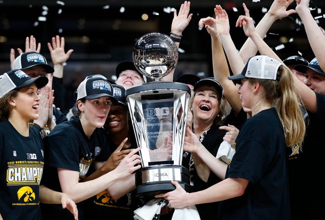 The Iowa Hawkeyes celebrate with the trophy after defeating the Indiana Hoosiers for the BIG Ten women's championship title Sunday, March 6, 2022, at Gainbridge Fieldhouse in Indianapolis. The final score was 74-67.