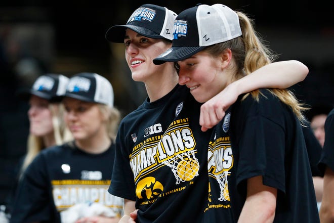 Iowa Hawkeyes guard Caitlin Clark (22) (left) and guard Kate Martin (20) celebrate after defeating the Indiana Hoosiers for the BIG Ten women's championship title Sunday, March 6, 2022, at Gainbridge Fieldhouse in Indianapolis. The final score was 74-67.