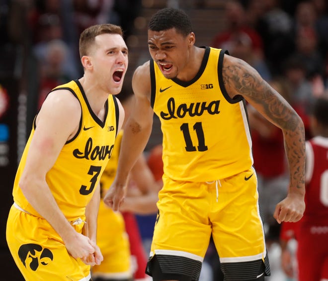 Iowa Hawkeyes guard Jordan Bohannon (3) and Iowa Hawkeyes guard Tony Perkins (11) celebrate during the men’s Big Ten tournament game against the Indiana Hoosiers, Saturday, March 12, 2022, at Gainbridge Fieldhouse in Indianapolis. The Hawkeyes won 80-77.