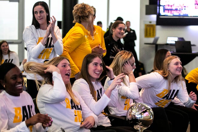 Iowa women's basketball players and guard Caitlin Clark, left, celebrate at a NCAA Tournament Selection Sunday watch party, Sunday, March 13, 2022, at Carver-Hawkeye Arena in Iowa City, Iowa.