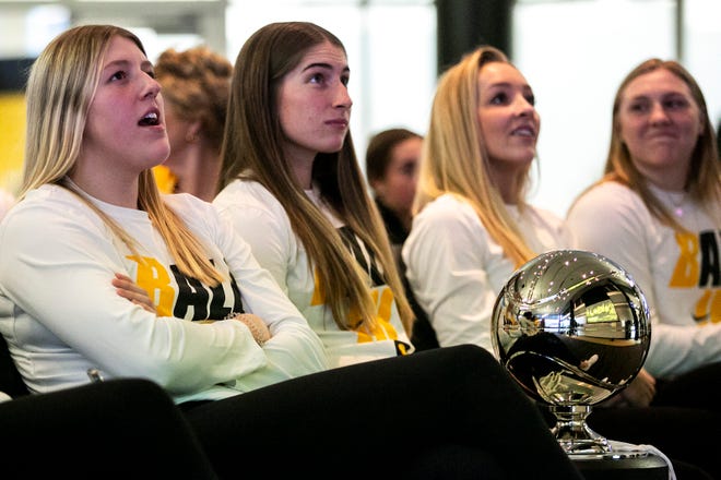 Iowa players, from left, Monika Czinano, Kate Martin and Kylie Feuerbach celebrate at a NCAA Tournament Selection Sunday watch party, Sunday, March 13, 2022, at Carver-Hawkeye Arena in Iowa City, Iowa.