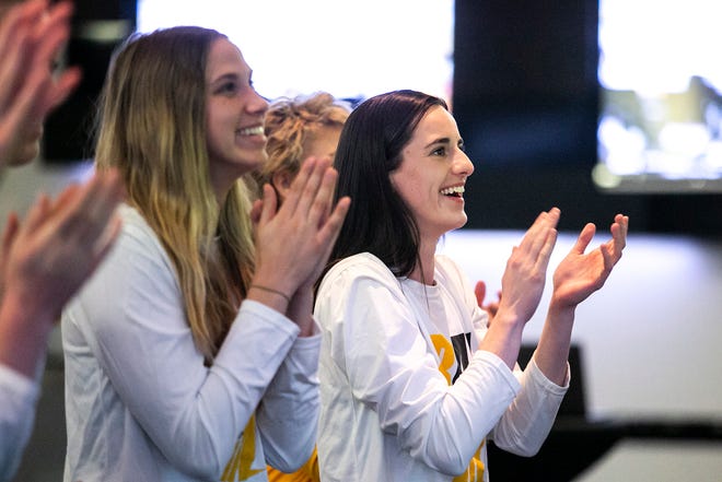 Iowa guard Caitlin Clark, right, celebrates with teammates at a NCAA Tournament Selection Sunday watch party, Sunday, March 13, 2022, at Carver-Hawkeye Arena in Iowa City, Iowa.
