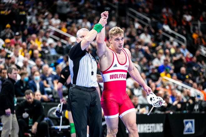 NC State's Hayden Hidlay has his hand raised after scoring a decision at 174 pounds for third place during the fifth session of the NCAA Division I Wrestling Championships, Saturday, March 19, 2022, at Little Caesars Arena in Detroit, Mich.