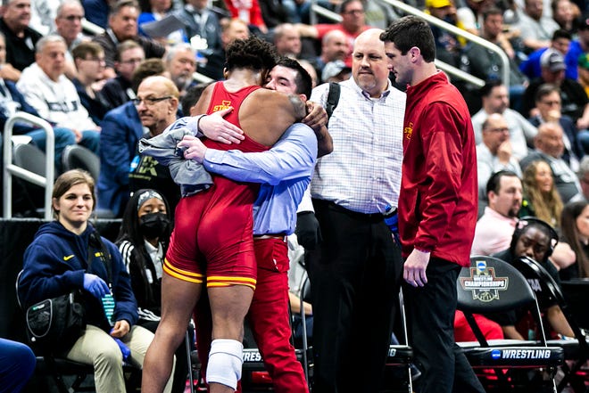 Iowa State's David Carr celebrates with coaches after scoring a decision at 157 pounds for third place during the fifth session of the NCAA Division I Wrestling Championships, Saturday, March 19, 2022, at Little Caesars Arena in Detroit, Mich.