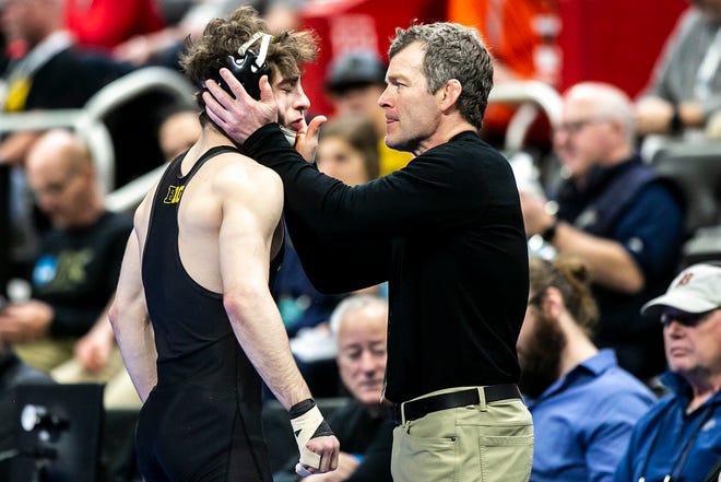 Iowa head coach Tom Brands smacks Iowa's Austin DeSanto in the face before he wrestles for third place at 133 pounds during the fifth session of the NCAA Division I Wrestling Championships, Saturday, March 19, 2022, at Little Caesars Arena in Detroit, Mich.