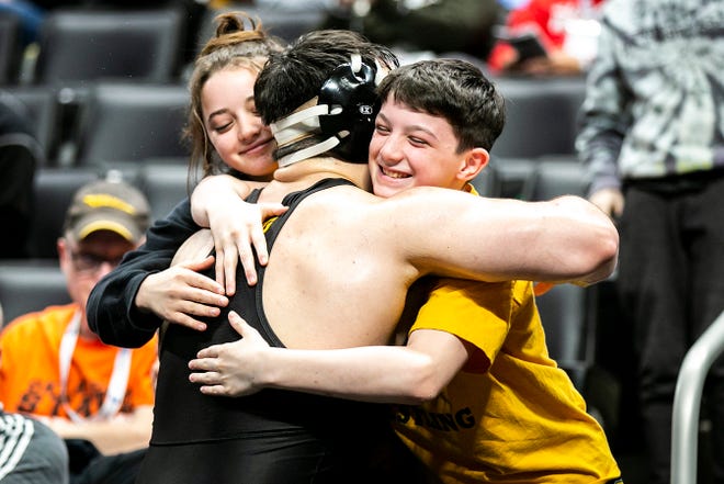 Iowa's Tony Cassioppi celebrates with his siblings after scoring a decision at 285 pounds for seventh place during the fifth session of the NCAA Division I Wrestling Championships, Saturday, March 19, 2022, at Little Caesars Arena in Detroit, Mich.
