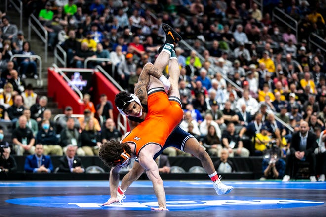 Penn State's Roman Bravo-Young, right, wrestles Oklahoma State's Daton Fix at 133 pounds in the finals during the sixth session of the NCAA Division I Wrestling Championships, Saturday, March 19, 2022, at Little Caesars Arena in Detroit, Mich.