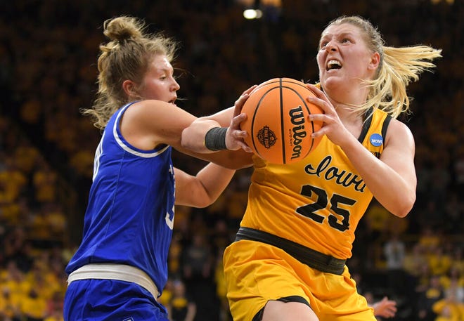 Iowa forward Monika Czinano (25) turns top the basket a Creighton guard Morgan Maly (30) defends during the second half of a second-round game in the NCAA women's college basketball tournament, Sunday, March 20, 2022, in Iowa City, Iowa. (AP Photo/Ron Johnson)