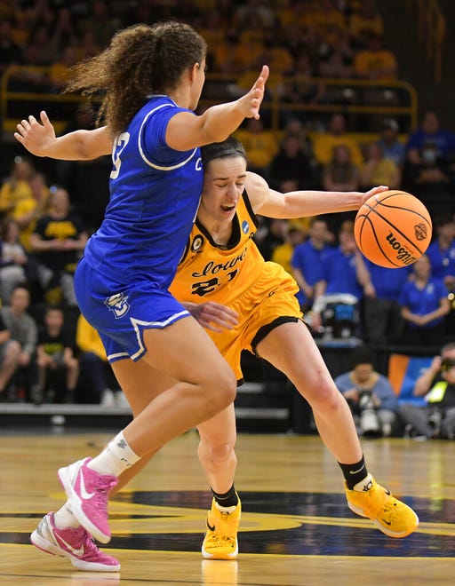 Iowa guard Caitlin Clark (22) drives the ball against Creighton guard Lauren Jensen (15) during the second half of a second-round game in the NCAA women's college basketball tournament, Sunday, March 20, 2022, in Iowa City, Iowa. (AP Photo/Ron Johnson)