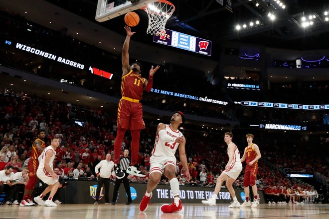 Iowa State Cyclones guard Tyrese Hunter (11) shoots the ball as Wisconsin Badgers guard Chucky Hepburn (23) sustains an injury during the first half in the second round of the 2022 NCAA Tournament at Fiserv Forum. Mandatory Credit: Jeff Hanisch-USA TODAY Sport