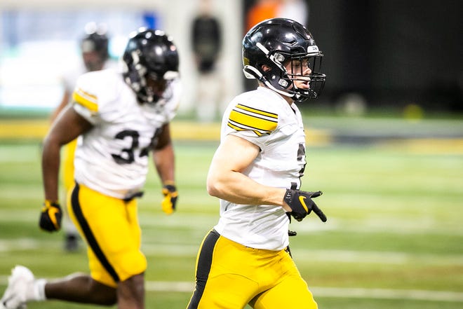 Iowa defensive back Cooper DeJean (3) warms up during a spring NCAA college football practice, Tuesday, March 29, 2022, at the University of Iowa Indoor Practice Facility in Iowa City, Iowa.