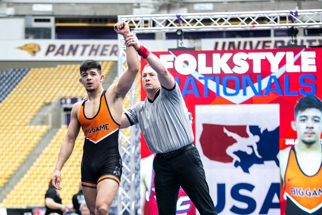 Hunter Garvin, left, has his hand raised after scoring a fall at 152 pounds in the finals during the USA Wrestling High School National Recruiting Showcase, Saturday, April 2, 2022, at the UNI-Dome in Cedar Falls, Iowa.