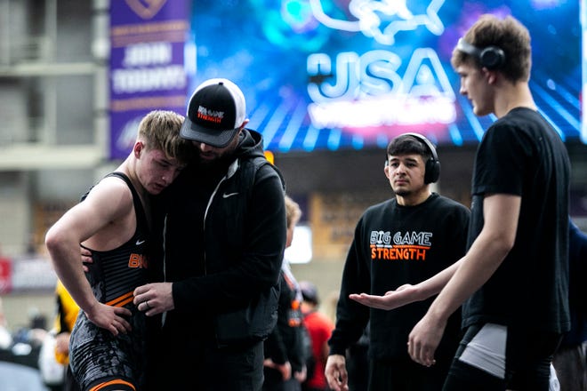Cale Seaton celebrates with teammates after scoring a decision at 126 pounds in the 16U finals during the USA Wrestling High School National Recruiting Showcase, Saturday, April 2, 2022, at the UNI-Dome in Cedar Falls, Iowa.