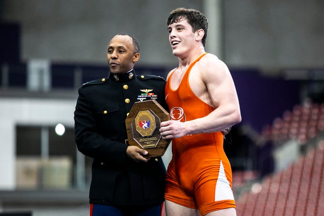 Wyatt Voelker, right, poses for a photo with his trophy after scoring a fall at 195 pounds in the finals during the USA Wrestling High School National Recruiting Showcase, Saturday, April 2, 2022, at the UNI-Dome in Cedar Falls, Iowa.
