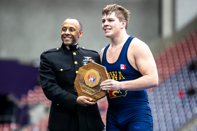 Jared Thiry, right, poses for a photo with his trophy after scoring a decision at 220 pounds in the finals during the USA Wrestling High School National Recruiting Showcase, Saturday, April 2, 2022, at the UNI-Dome in Cedar Falls, Iowa.