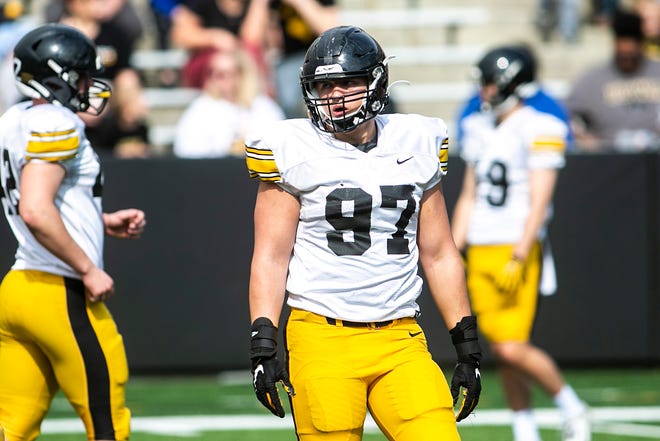 Iowa defensive lineman Caden Crawford (97) listens to instructions between drills during the Hawkeyes' final spring NCAA football practice, Saturday, April 23, 2022, at Kinnick Stadium in Iowa City, Iowa.