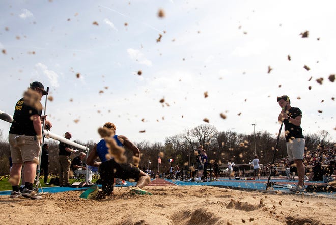 Sand splashes out of the long jump pit during the Musco Twilight NCAA outdoor track and field meet, Saturday, April 23, 2022, at Francis X. Cretzmeyer Track in Iowa City, Iowa.