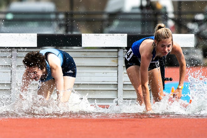 Iowa Western Community College's Josey French, right, and Iowa Central Community College's Kate Miron splash down into the water competing in the 3,000 meter steeplechase during the Musco Twilight NCAA outdoor track and field meet, Saturday, April 23, 2022, at Francis X. Cretzmeyer Track in Iowa City, Iowa.