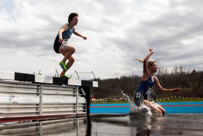 Iowa Western Community College's Josey French, right, and Iowa Central Community College's Kate Miron splash down into the water competing in the 3,000 meter steeplechase during the Musco Twilight NCAA outdoor track and field meet, Saturday, April 23, 2022, at Francis X. Cretzmeyer Track in Iowa City, Iowa.