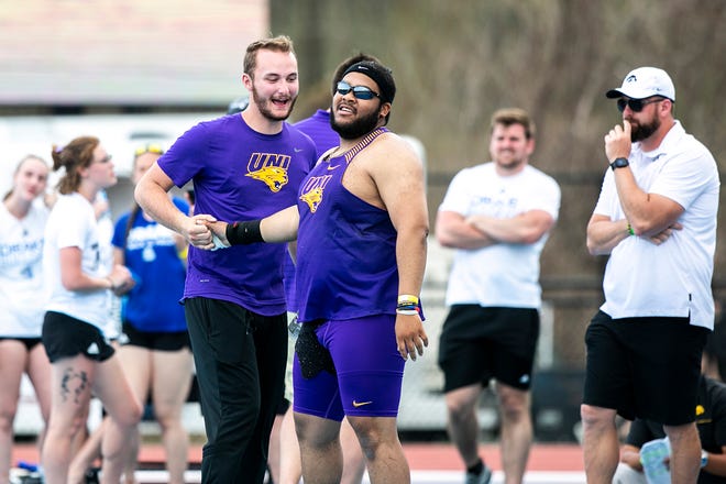 Northern Iowa's Darius King is embraced by teammates after a throw while competing in shot put during the Musco Twilight NCAA outdoor track and field meet, Saturday, April 23, 2022, at Francis X. Cretzmeyer Track in Iowa City, Iowa.