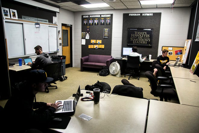 Iowa baseball data analysts, from left, Reed Zahradnik, Austin Marchesani, Andrew Sumner, and Luke Statler work on inputting information they collected during a NCAA Big Ten Conference baseball game against Indiana, Friday, May 20, 2022, at the Jacobson Athletic Building in Iowa City, Iowa.