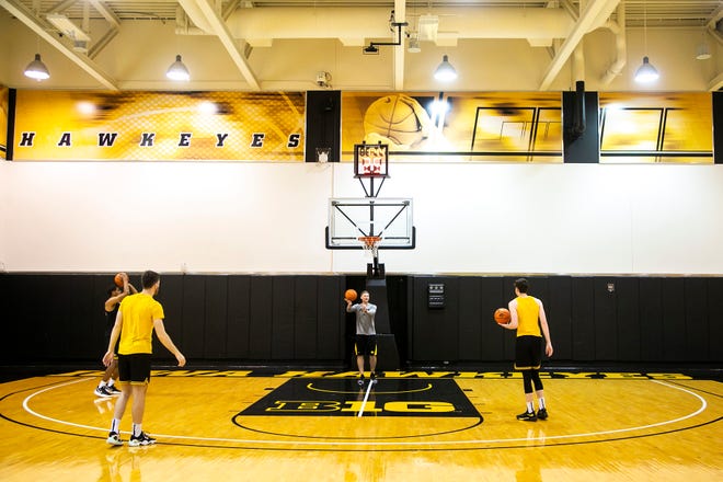 Iowa assistant coach Matt Gatens rebounds a ball as players warm up during a NCAA men's basketball summer practice, Wednesday, June 15, 2022, at Carver-Hawkeye Arena in Iowa City, Iowa.