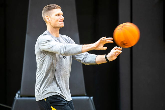 Iowa assistant coach Matt Gatens passes a ball as players warm up during a NCAA men's basketball summer practice, Wednesday, June 15, 2022, at Carver-Hawkeye Arena in Iowa City, Iowa.
