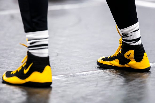 A wrestler wears Nike socks with black and yellow shoes during a girls wrestling technique camp, Wednesday, July 6, 2022, at the GreenState Family Fieldhouse in Coralville, Iowa.