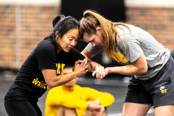 Iowa women's wrestling head coach Clarissa Chun, left, demonstrates a move with Hawkeye Wrestling Club member Rachel Watters during a girls wrestling technique camp, Wednesday, July 6, 2022, at the GreenState Family Fieldhouse in Coralville, Iowa.