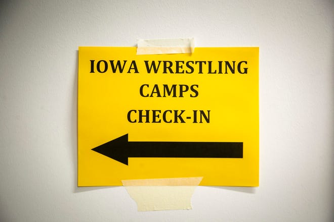 A sign for an Iowa girls wrestling technique camp is seen, Wednesday, July 6, 2022, at the GreenState Family Fieldhouse in Coralville, Iowa.
