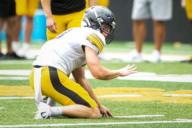 Iowa defensive back Cooper DeJean gets set for a hold during the Kids Day at Kinnick NCAA football practice, Saturday, Aug. 13, 2022, at Kinnick Stadium in Iowa City, Iowa.