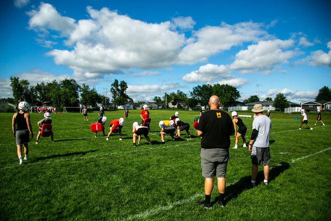 Marion head coach Michael Joyner watches a play during a high school football practice, Monday, Aug. 8, 2022, at Marion High School in Marion, Iowa.