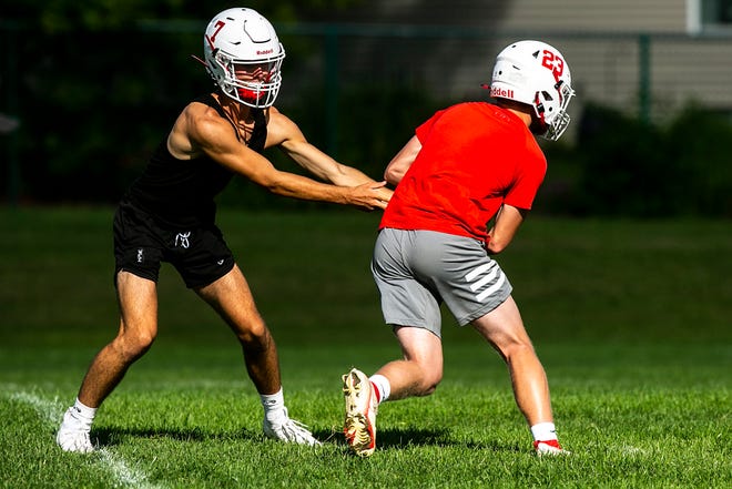 Marion's Coda Johnson, left, hands the ball off to Jasper Hancox during a high school football practice, Monday, Aug. 8, 2022, at Marion High School in Marion, Iowa.
