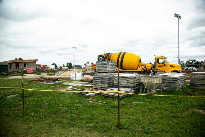 A Hawkeye Ready-Mix concrete truck is seen as construction continues on the new football field, Monday, Aug. 8, 2022, at Marion High School in Marion, Iowa.