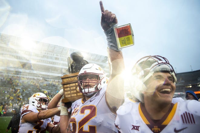 Iowa State offensive lineman Trevor Downing celebrates with the Cy-Hawk trophy after a NCAA football game against Iowa, Saturday, Sept. 10, 2022, at Kinnick Stadium in Iowa City, Iowa.