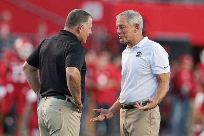 Sep 24, 2022; Piscataway, New Jersey, USA; Iowa Hawkeyes head coach Kirk Ferentz (right) talks with Rutgers Scarlet Knights head coach Greg Schiano before the game at SHI Stadium. Mandatory Credit: Vincent Carchietta-USA TODAY Sports