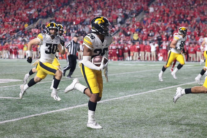 Sep 24, 2022; Piscataway, New Jersey, USA; Iowa Hawkeyes defensive back Kaevon Merriweather (26) returns a fumble for a touchdown during the first half against the Rutgers Scarlet Knights at SHI Stadium. Mandatory Credit: Vincent Carchietta-USA TODAY Sports