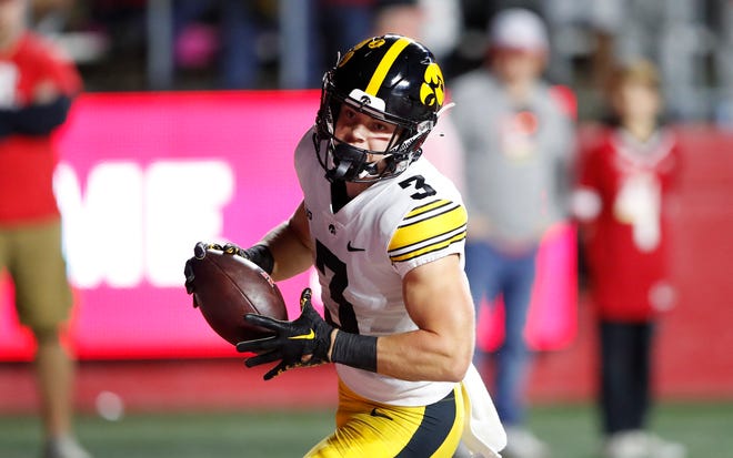 Iowa defensive back Cooper DeJean (3) returns an interception for a touchdown against Rutgers during the first half of an NCAA college football game, Saturday, Sept. 24, 2022, in Piscataway, N.J.