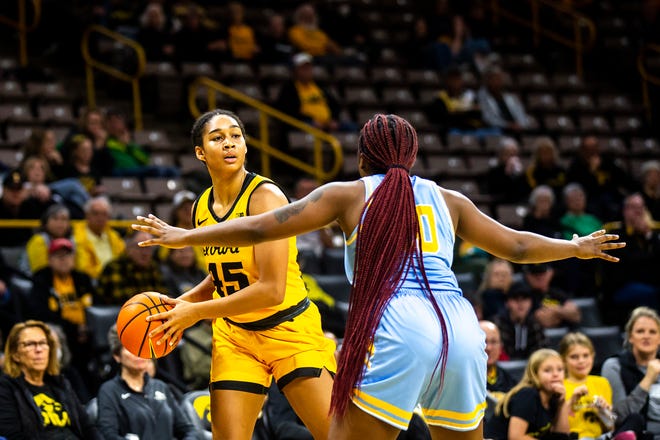Iowa forward Hannah Stuelke, left, looks to pass during a NCAA women's basketball game against Southern University, Monday, Nov. 7, 2022, at Carver-Hawkeye Arena in Iowa City, Iowa.