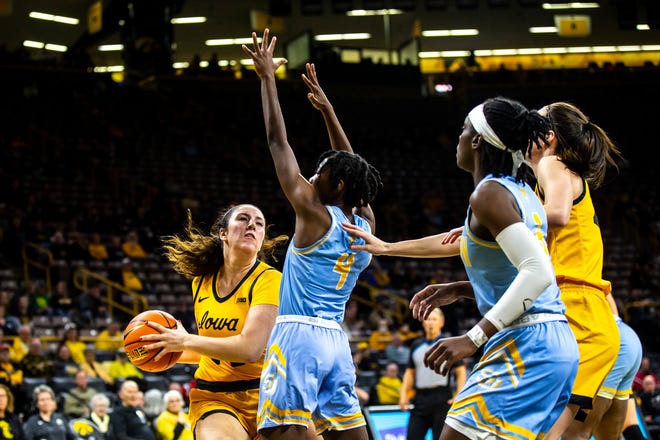 Iowa's McKenna Warnock, left, drives to the basket as Southern University guard Chloe Fleming (4) defends during a NCAA women's basketball game, Monday, Nov. 7, 2022, at Carver-Hawkeye Arena in Iowa City, Iowa.
