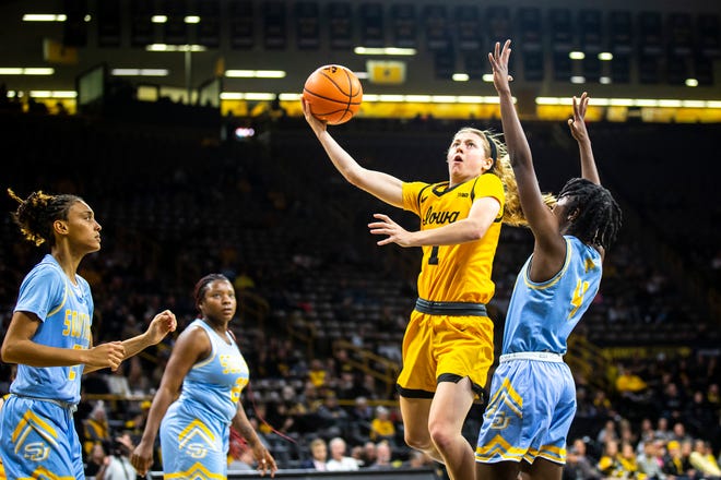 Iowa guard Molly Davis (1) shoots a basket as Southern University guard Chloe Fleming (4) defends during a NCAA women's basketball game, Monday, Nov. 7, 2022, at Carver-Hawkeye Arena in Iowa City, Iowa.