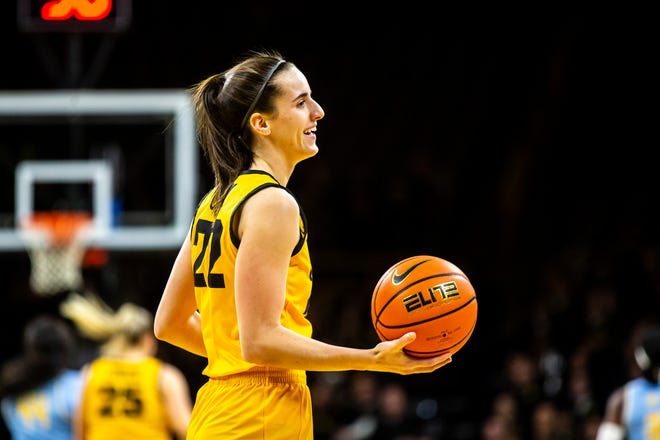 Iowa guard Caitlin Clark (22) smiles while holding a ball during a NCAA women's basketball game against Southern University, Monday, Nov. 7, 2022, at Carver-Hawkeye Arena in Iowa City, Iowa.