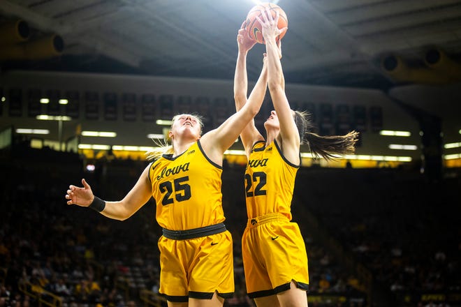 Iowa center Monika Czinano, left, and guard Caitlin Clark go up for a rebound during a NCAA women's basketball game against Southern University, Monday, Nov. 7, 2022, at Carver-Hawkeye Arena in Iowa City, Iowa.